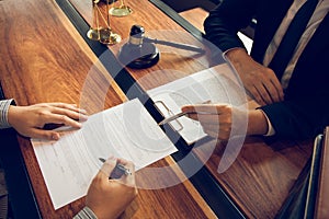 Lawyer is explaining about the wrongdoing laws regarding fraud to the client at the office