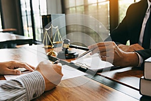 Lawyer is explaining about the wrongdoing laws regarding fraud to the client at the office