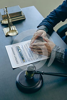 A lawyer explains to a client the law that must be applied to a court case. With contract documents