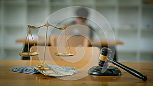Lawyer hammer and golden scales of justice on money legal