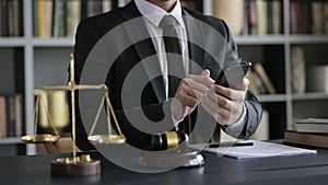 Lawyer Hand USing Smartphone in Court Room