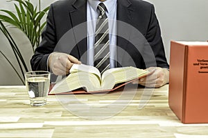 Lawyer in his office with books