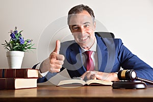 Lawyer in his office making ok sign with his hand