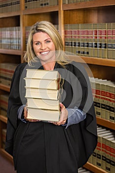 Lawyer holding books in the law library