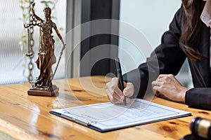 Lawyer holding contract documents in hand and preparing to sign a consulting contract for a team of business people who need legal