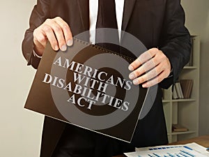 Lawyer holds Americans with Disabilities Act ADA book photo
