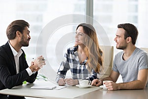 Lawyer, insurer or salesman consulting happy millennial couple making offer