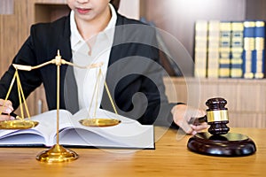 lawyer judge reading documents at desk in courtroom working on wooden desk background. gavel golden Weight. and soundblock of