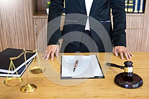 lawyer judge reading documents at desk in courtroom working on wooden desk background. gavel  golden Weight. and soundblock of