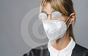 Lawyer or judge wearing N95 FFP2 an anti virus protection mask are fogged up to prevent others from corona COVID-19 and SARS cov 2