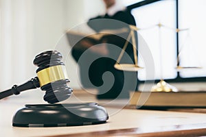 Lawyer or judge work in the office with gavel and balance.
