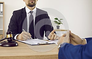 Lawyer meeting client in his office, giving consultation and sharing legal advice