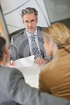 Lawyer meeting clients in his office