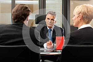 Lawyer or notary with clients in his office