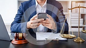 Lawyer office. gavel of Justice with scales and lawyer working on a smartphone and laptop. Legal law, advice and justice concept