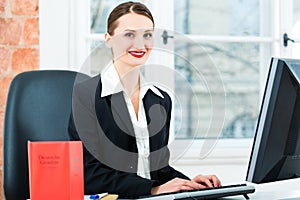 Lawyer in office making notes in a file