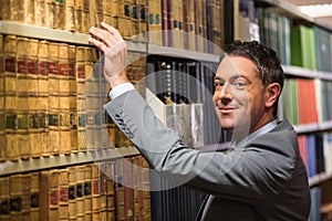 Lawyer picking book in the law library