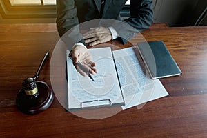 Lawyer present client with contract papers on the table in office. consultant lawyer, attorney, court judge, concept photo