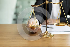 The lawyer puts a second hand on the scales of justice on his desk, stating that the matter must be justified and not contrary to