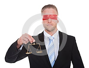 Lawyer with scales of justice wearing a blindfold photo