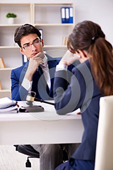 The lawyer talking to his client in office