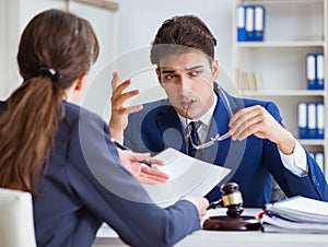 Lawyer talking to his client in office