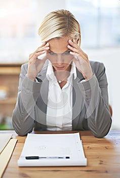 Lawyer, woman and headache at office desk with paperwork, stress and tired of case investigation. Advocate, attorney or