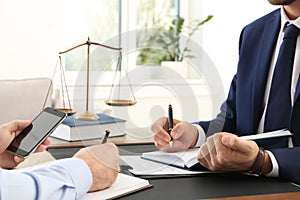 Lawyer working with client at table in offic