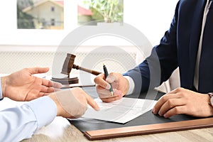 Lawyer working with client at table in office