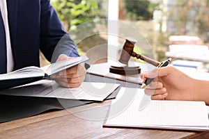 Lawyer working with client at table in office