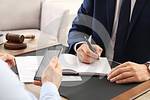 Lawyer working with client at table in office