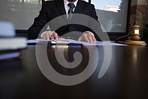 Lawyer working with contract papers on the table in office. consultant lawyer, attorney, court judge, concept