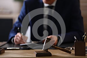 Lawyer working at table in office, focus on gavel