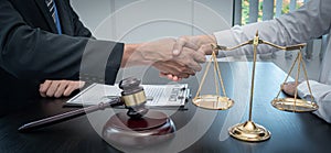 Lawyers or attorneys shake hands to congratulate the clients who have proceeded the matter with accuracy and fairness allowing the