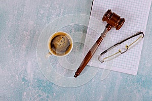 Lawyers Judge desk with wooden judges gavel a cup of coffee, notebook of reading glasses