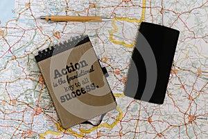 Lay flat of map, notebook and phone