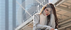 Lay off. Sacked. Fired business woman sitting on stairs of office building outside