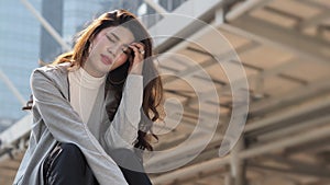 Lay off. Sacked. Fired business woman sitting on stairs of office building outside