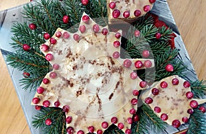 Layer cake in the form of an autumn maple leaf, decorated with cranberries, close-up, top view