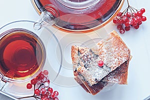 Layer cake with poppy seeds with hot berry tea on a winter day. Top view