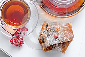Layer cake with poppy seeds with hot berry tea on a winter day. Top view