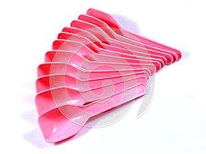 A layer of pink plastic baby spoon.