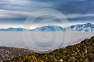 Thick Layer of Smog With Snow Capped Mountains In Background