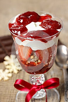 Layer strawberry and muesli dessert in glass goblet