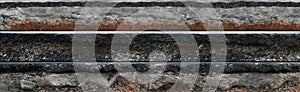 Layered asphalt road side texture with soil geology cross section underground earth
