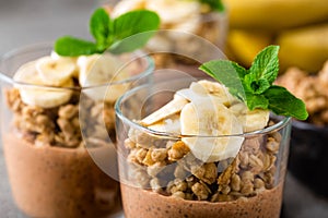 Layered chocolate chia pudding parfait with banana, granola and yogurt, dessert