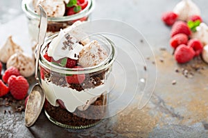 Layered dessert with chocolate cake and whipped cream