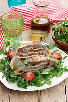 Layered meat pies with green salad