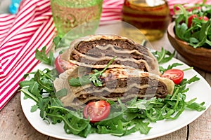 Layered meat pies with green salad