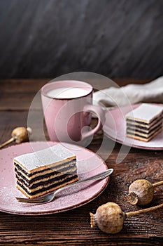 Layered poppy seed cake dusted with powdered sugar